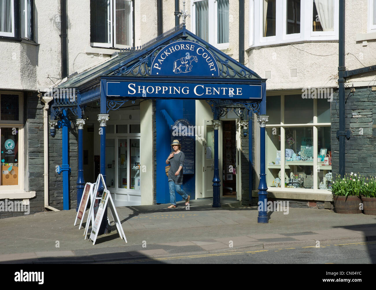 Young woman walking into the Packhorse Court Shopping Centre, Keswick
