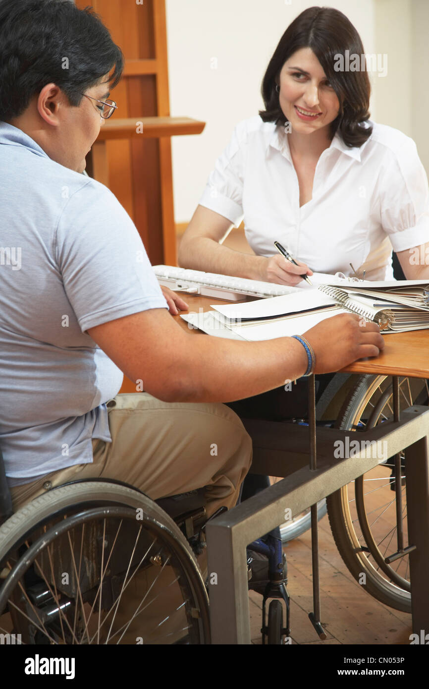 Handicapped Man and Woman in Business Meeting Stock Photo - Alamy