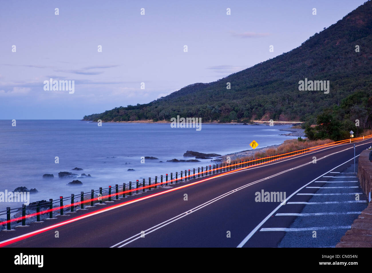 Car light trails on coastal highway. Captain Cook Highway between Port