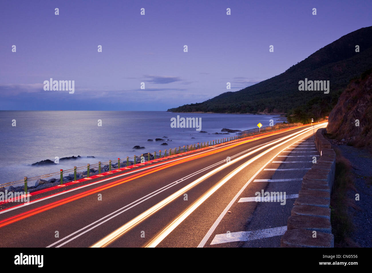 Car light trails on coastal highway. Captain Cook Highway between Port Douglas and Cairns, Queensland, Australia Stock Photo