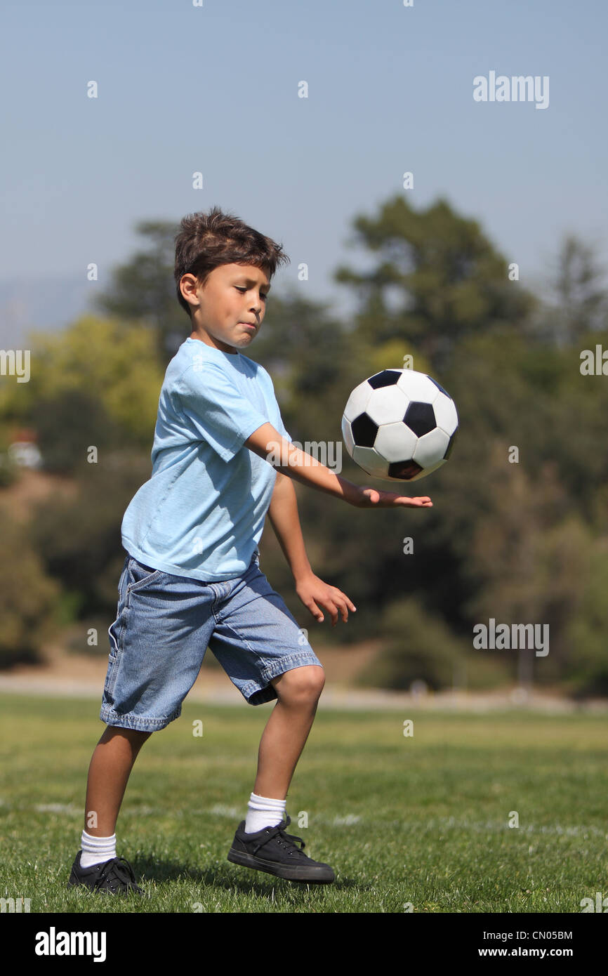 A young boy prepares to kick a soccer ball Stock Photo Alamy