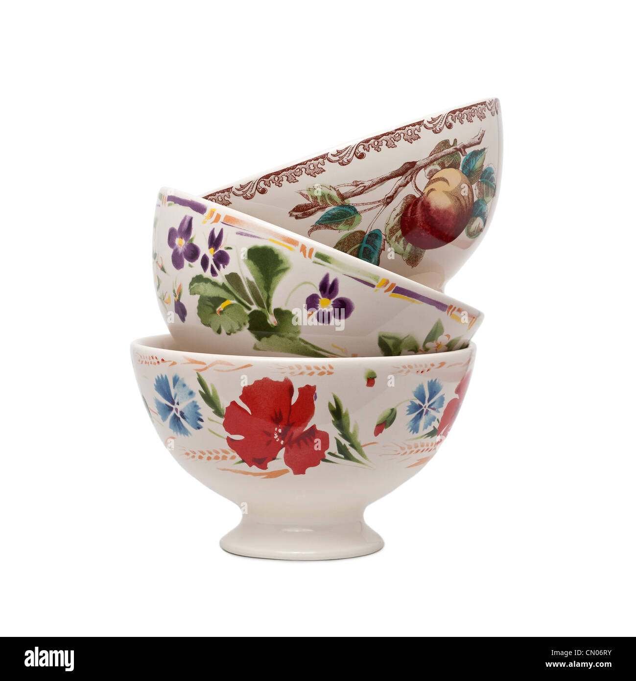 Glazed earthenware bowls with hand-applied patterns. Bols en faïence émaillée avec motifs appliqués à la main. Stock Photo