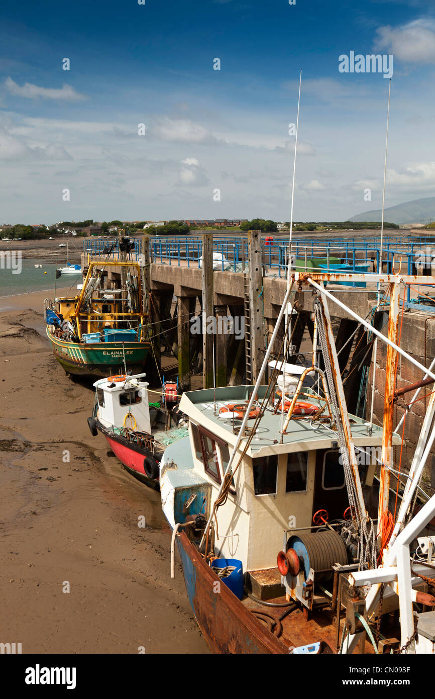 UK, Cumbria, Barrow in Furness, fishing boats moored at working quay at low tide Stock Photo