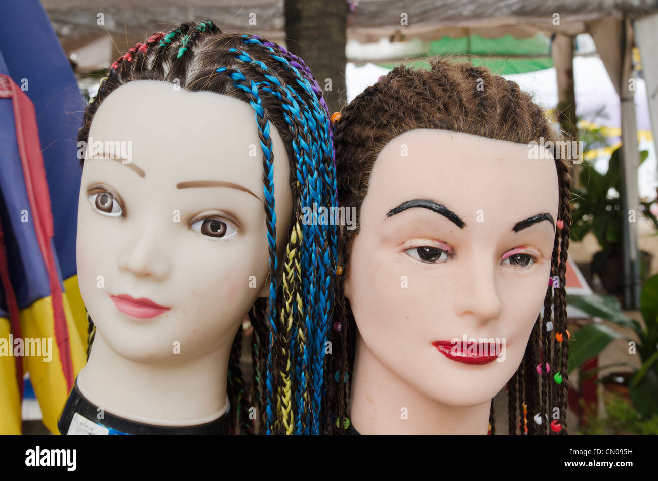 Mannequin heads with hair braiding, advertising services available along  Kamala Beach in Phuket, Thailand Stock Photo - Alamy