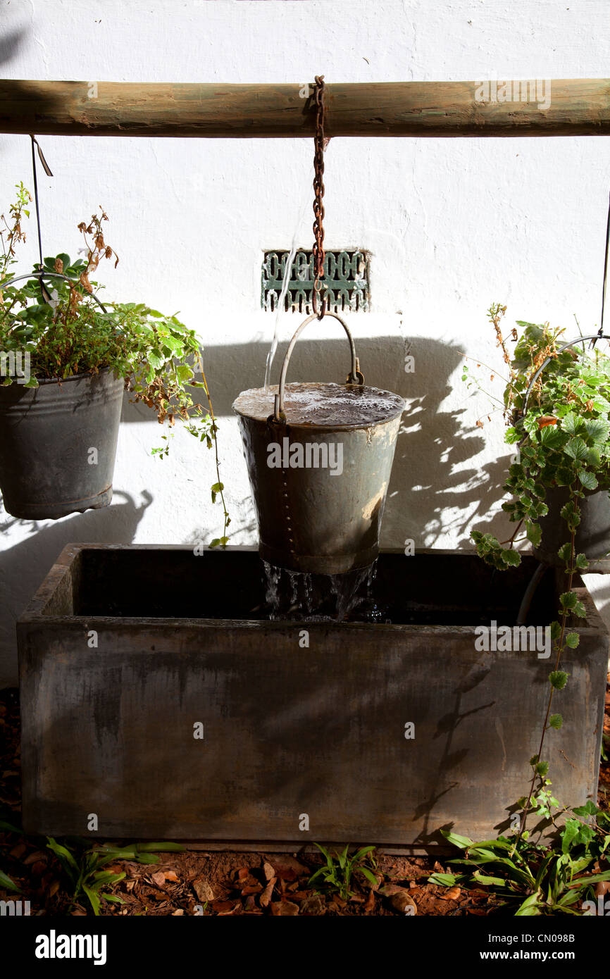 Metal bucket water feature Stock Photo Alamy