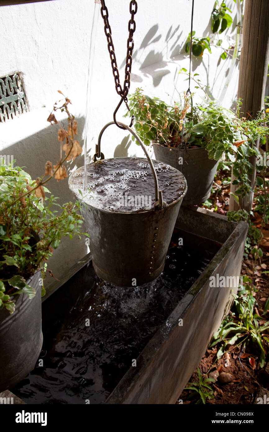 Metal bucket water feature Stock Photo Alamy
