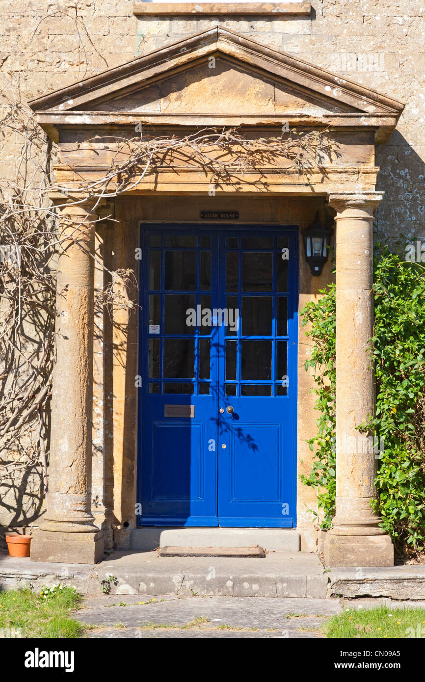 Brightly painted house door under elegant portico, Crewkerne, Somerset Stock Photo
