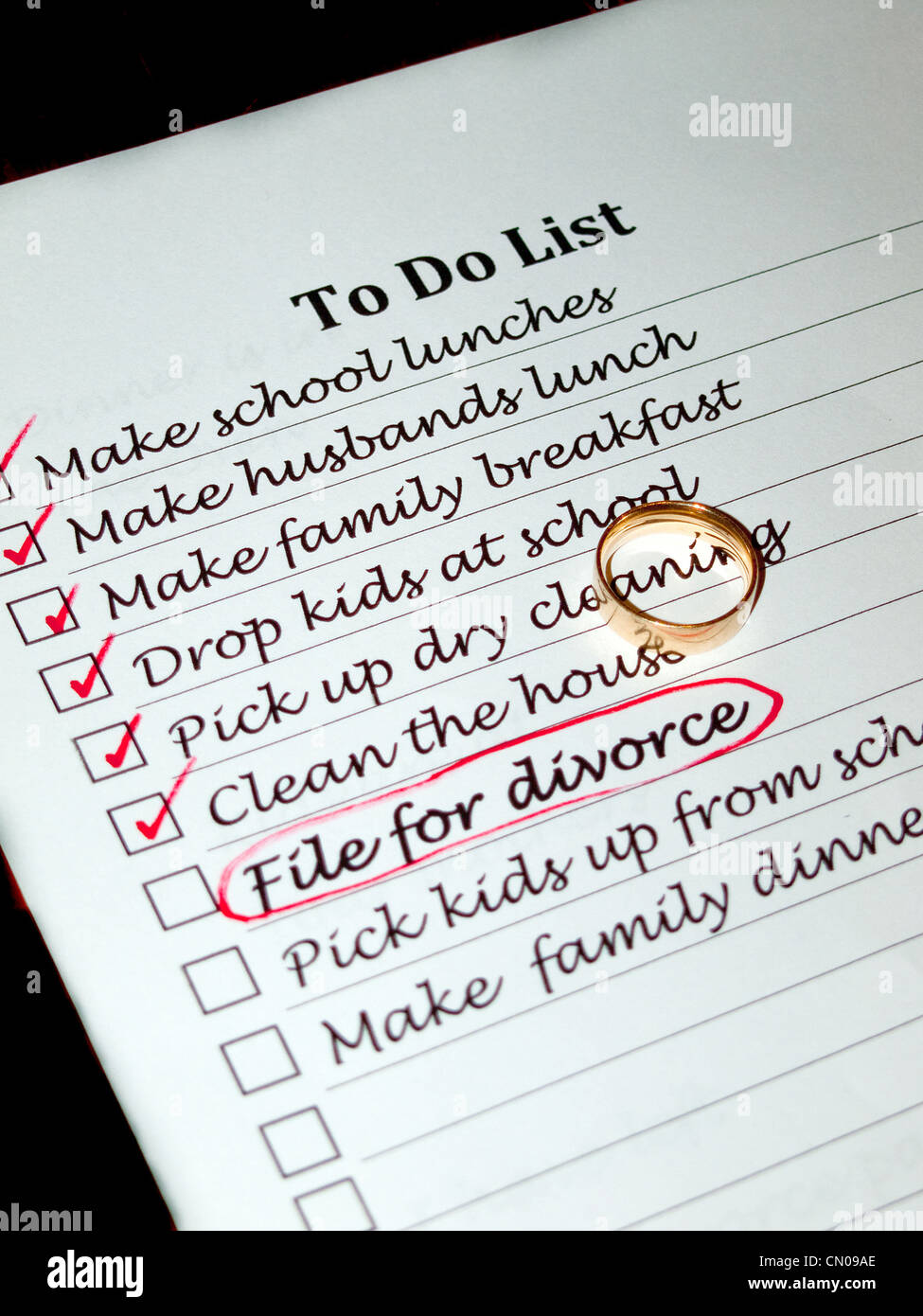 A wifes to do list containing the item file for divorce with a wedding ring placed on top of the list Stock Photo