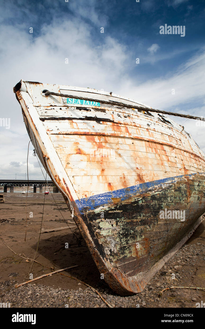 UK, Cumbria, Barrow in Furness, Walney Channel, fishing boat Sea Jade at angle at low tide, whilst being restored Stock Photo