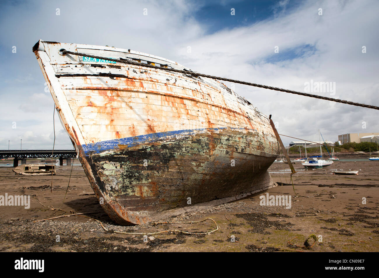 UK, Cumbria, Barrow in Furness, Walney Channel, fishing boat Sea Jade at angle at low tide, whilst being restored Stock Photo