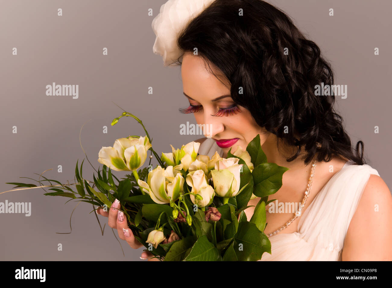 Portrait of a beautiful happy bride with bouquet in studio Stock Photo ...