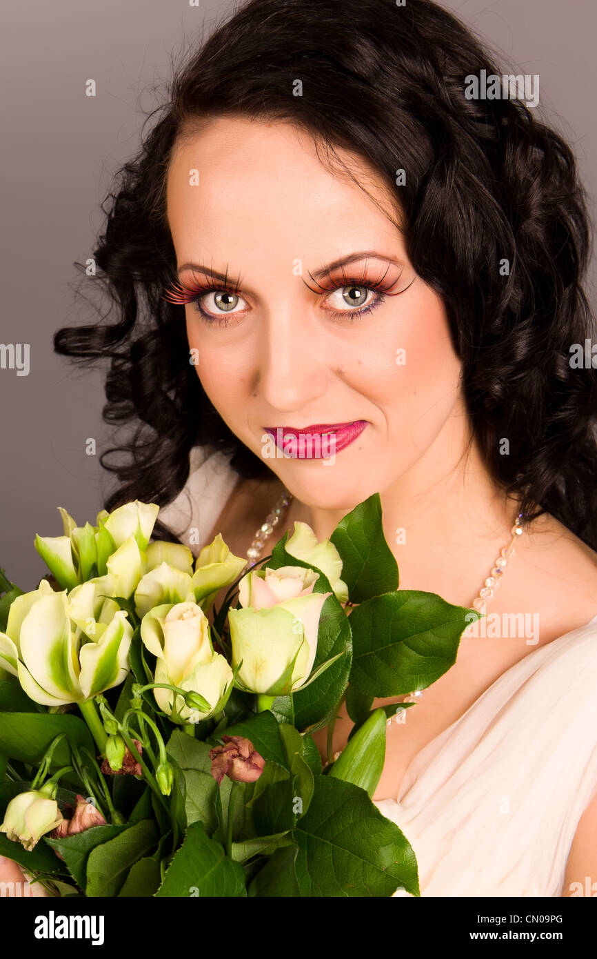 Portrait of a beautiful happy bride with bouquet in studio Stock Photo ...