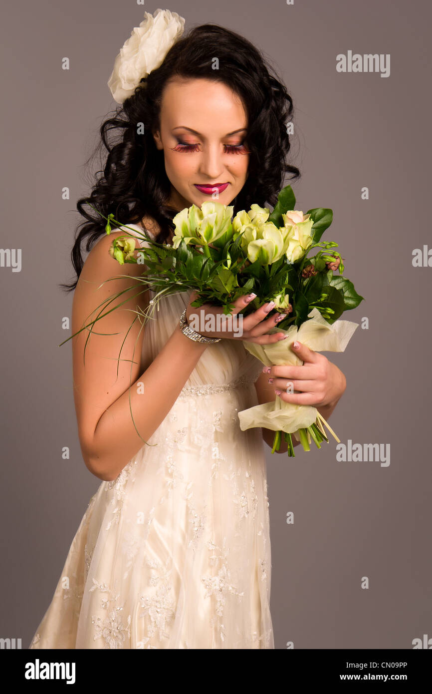 Portrait of a beautiful happy bride with bouquet in studio Stock Photo ...