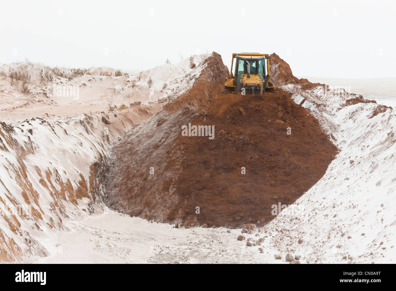 The bulldozer buries slurry pit in the works for the recultivation of drilling sites Stock Photo