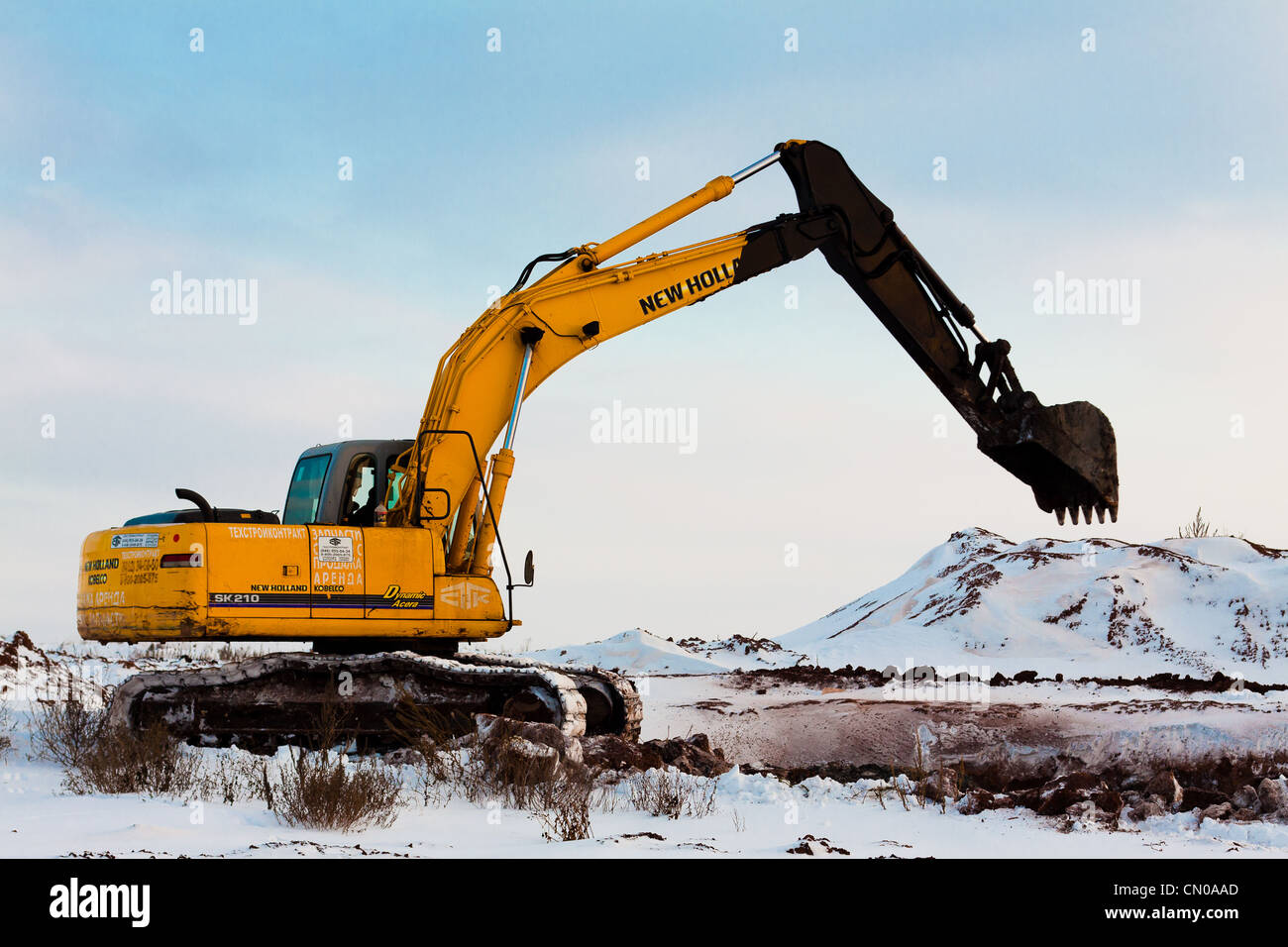 Excavator 'Kobelco SK210 LC Hydraulic'  with a black bucket in the works for the recultivation of drilling sites Stock Photo