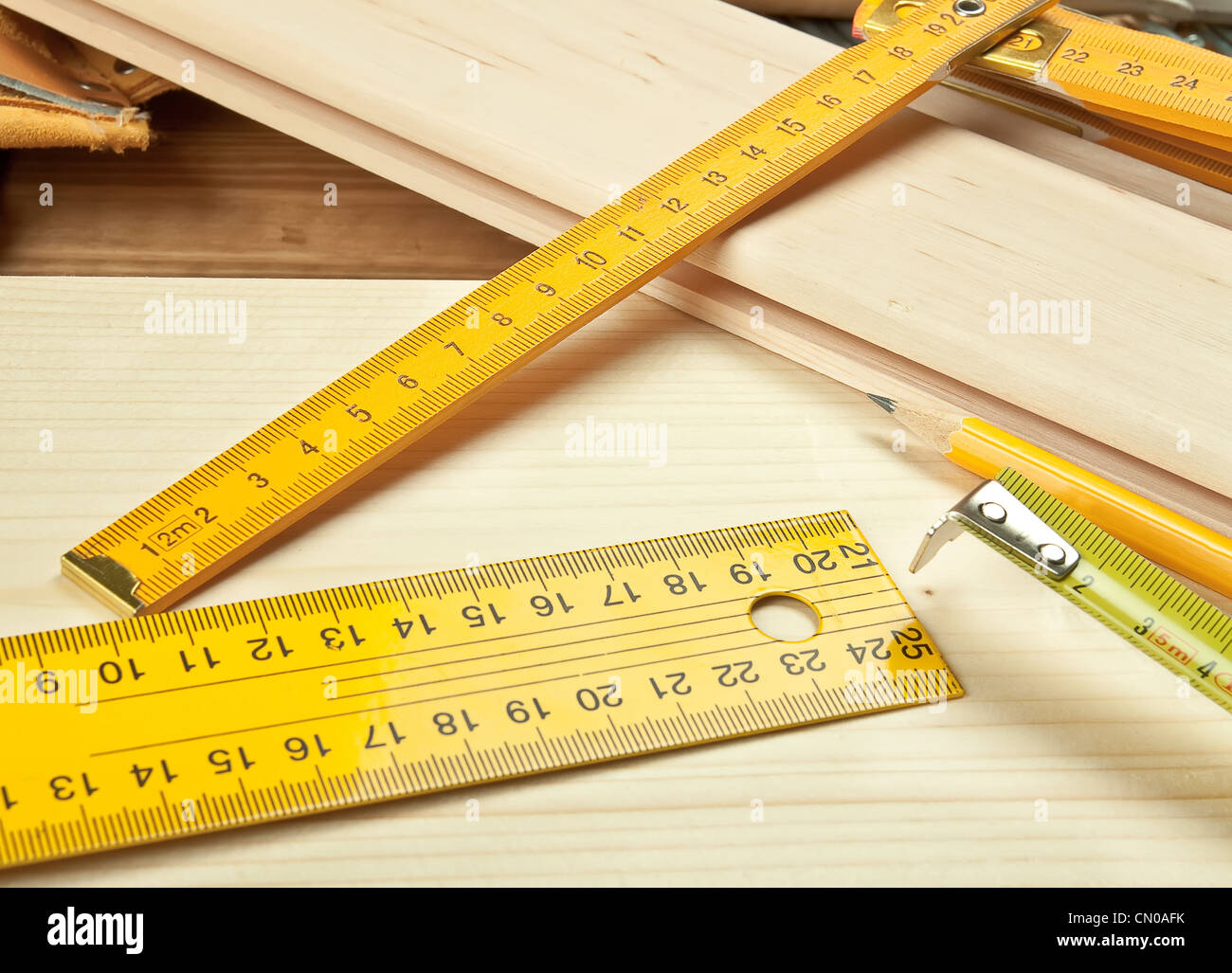Rulers on a wooden background. Stock Photo