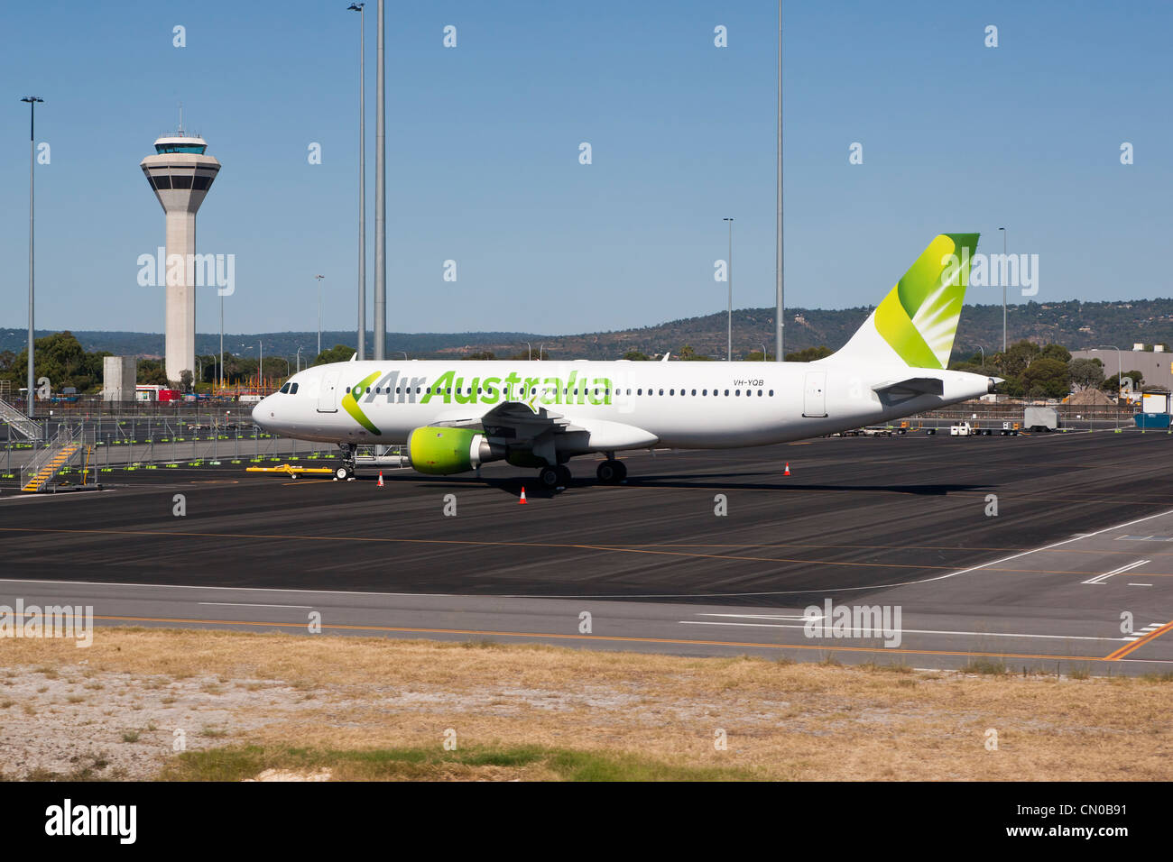 Air Australia Parked at Perth Airport with Control Tower Stock Photo