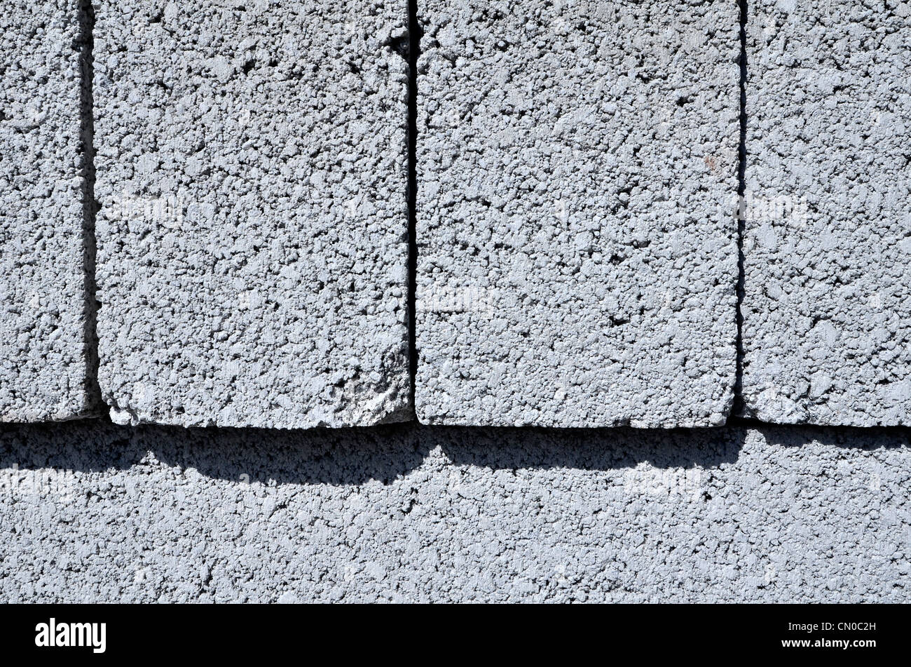 Closer detail of stacked concrete building blocks on construction site. Metaphor construction industry, construction supplies, building materials. Stock Photo