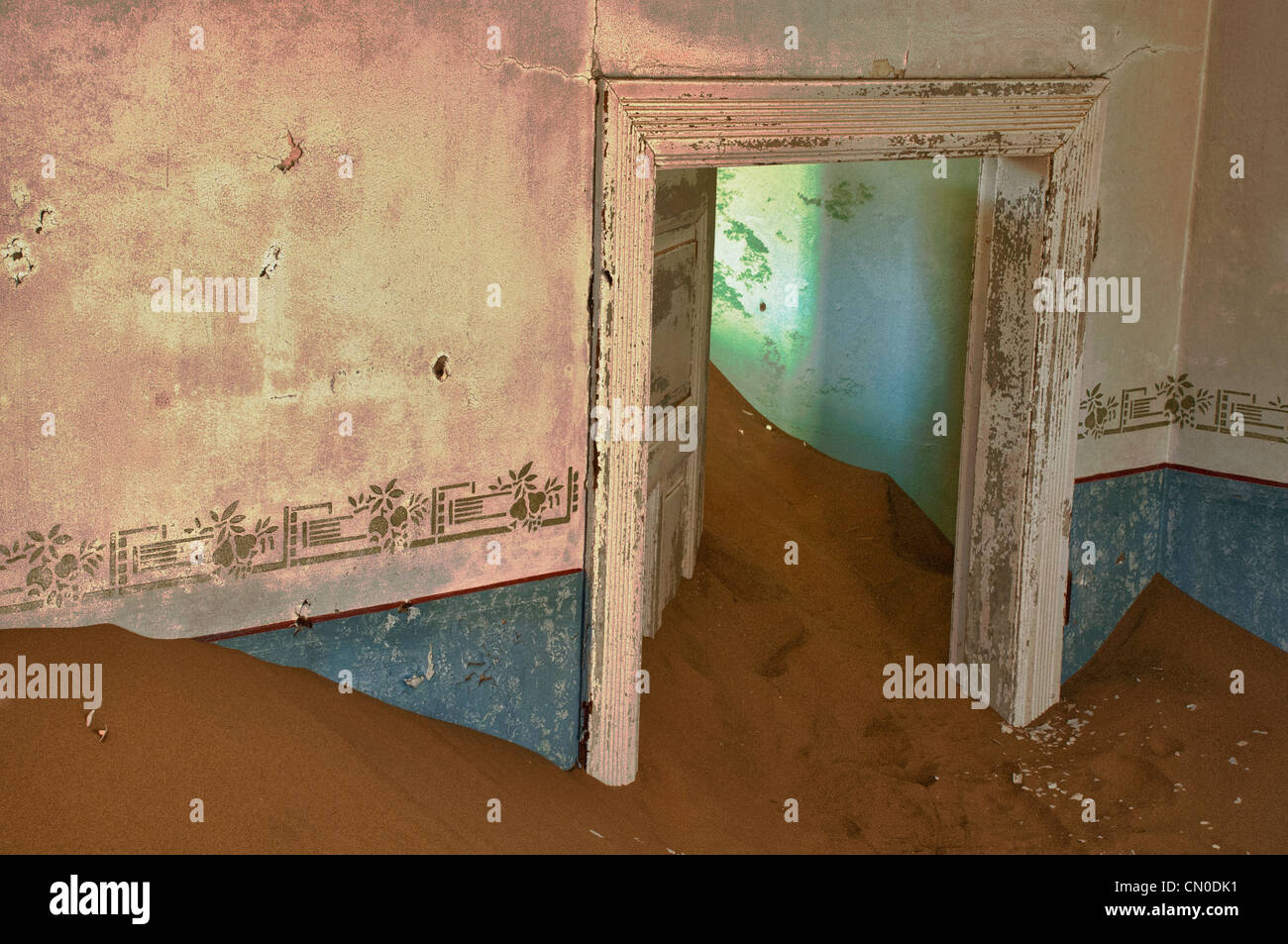 Interior room in Kolmanskop, a ghost mining town in Namibia, Africa. The desert has reclaimed the town after it was abandoned. Stock Photo