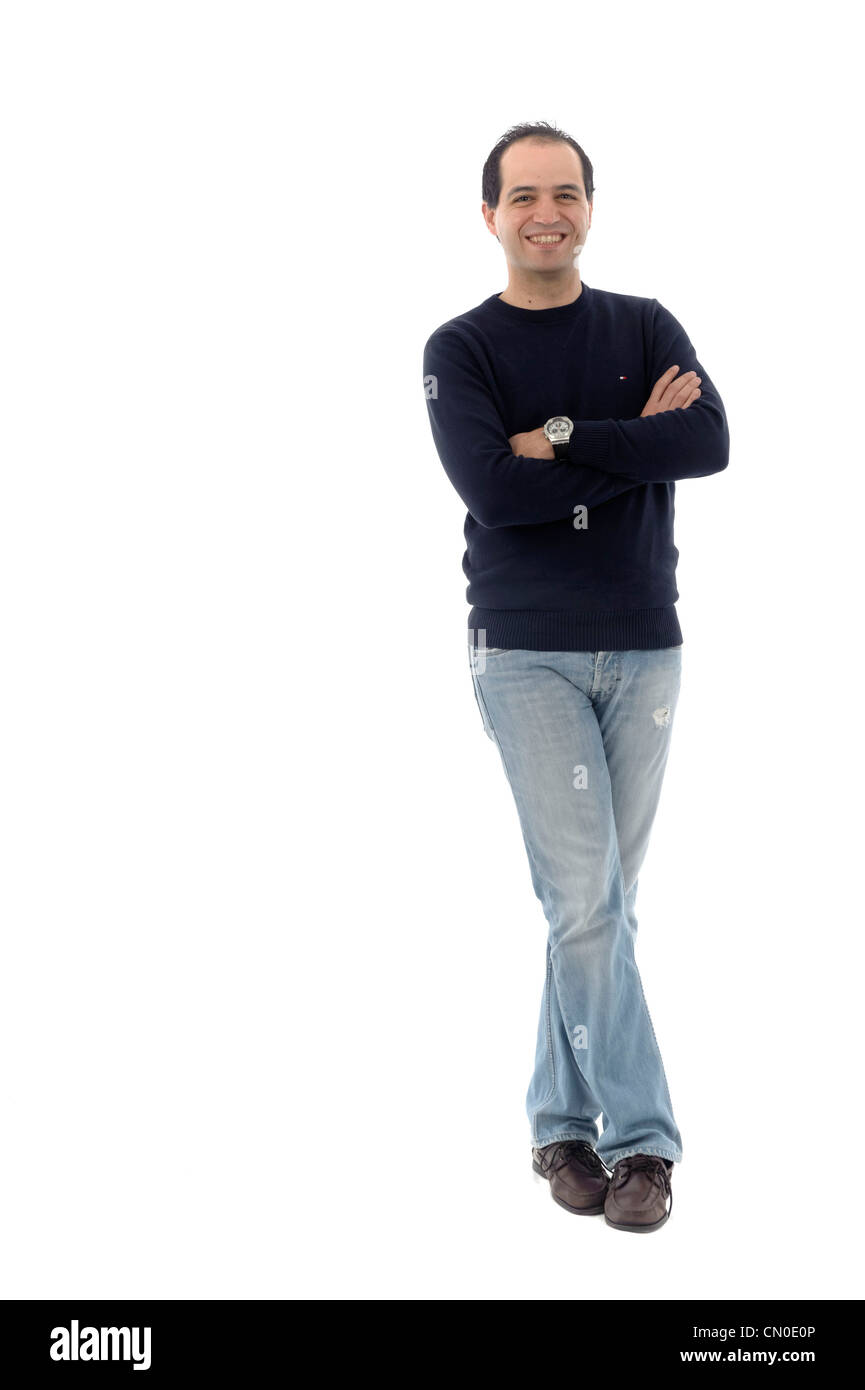 Full length portrait of young man with arms crossed isolated on white background Stock Photo