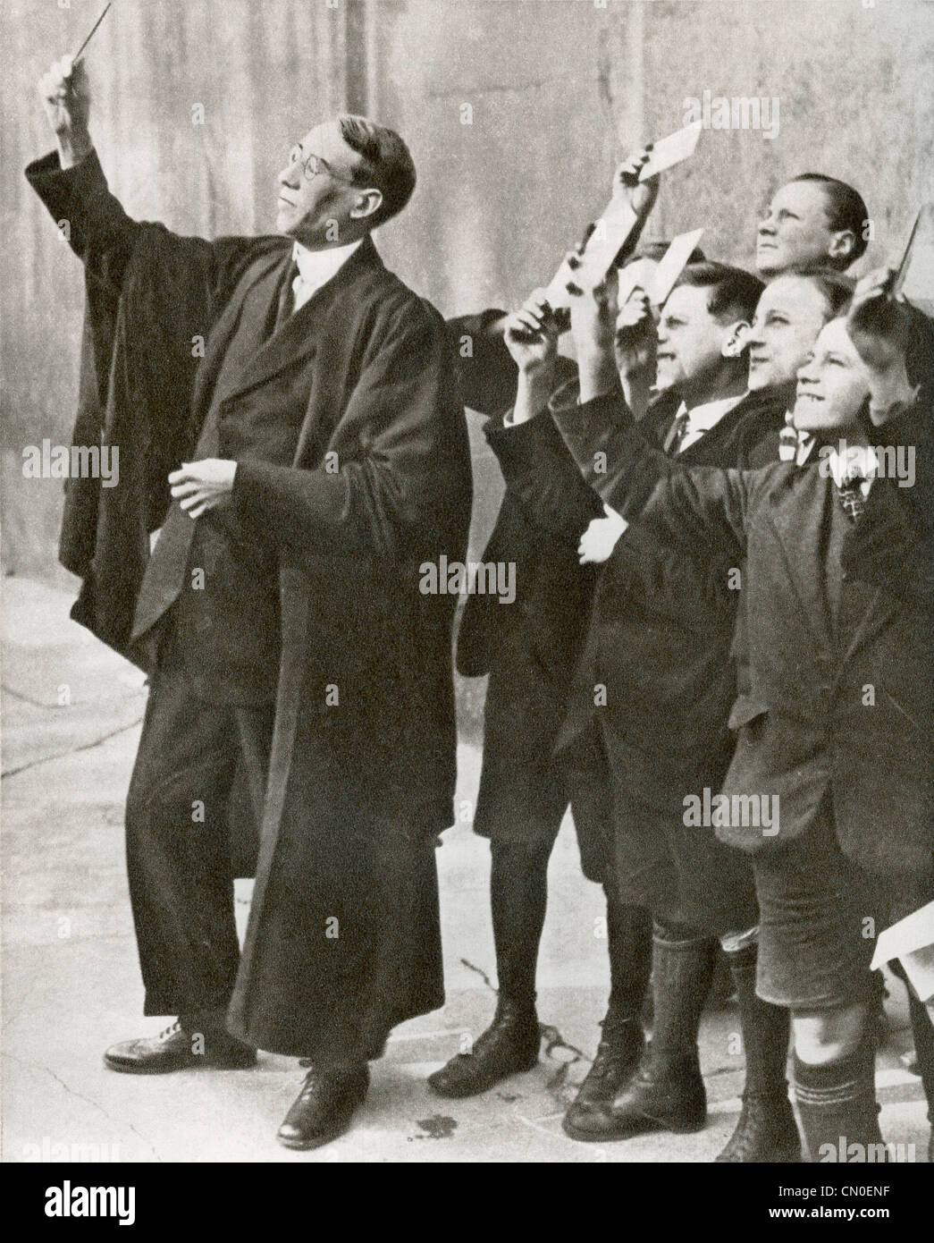 A teacher and his pupils using smoked glass to observe the eclipse of the sun in 1921. Stock Photo