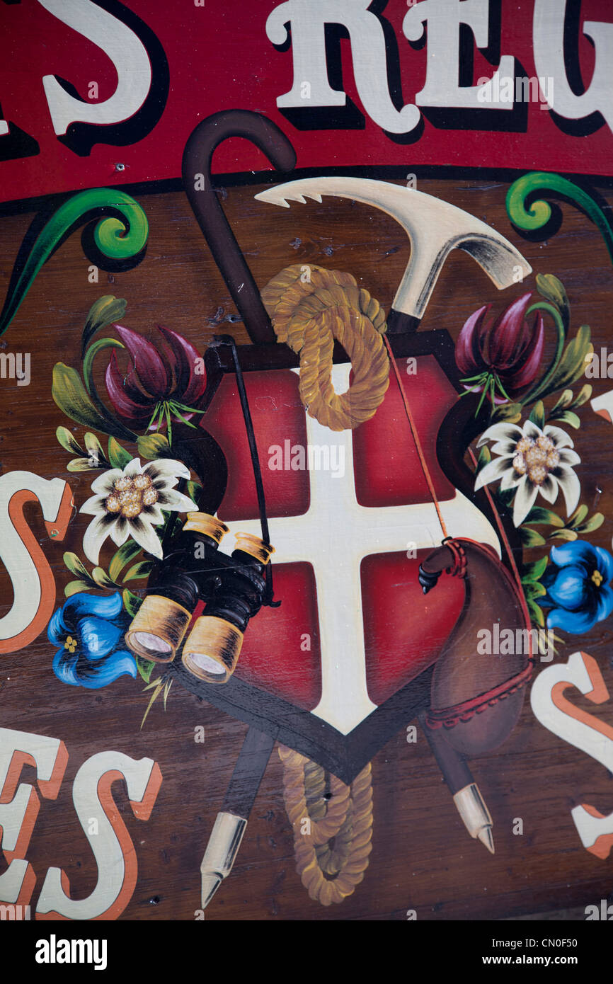 Murial on delicatessant shop side, showing swiss flag and climbing equipment, at Argentiere. Stock Photo