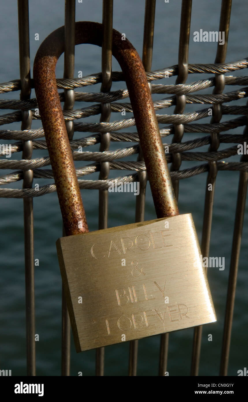 Padlocks on bridges over the River Seine in Paris, usually attached by lovers to symbolise their togetherness Stock Photo