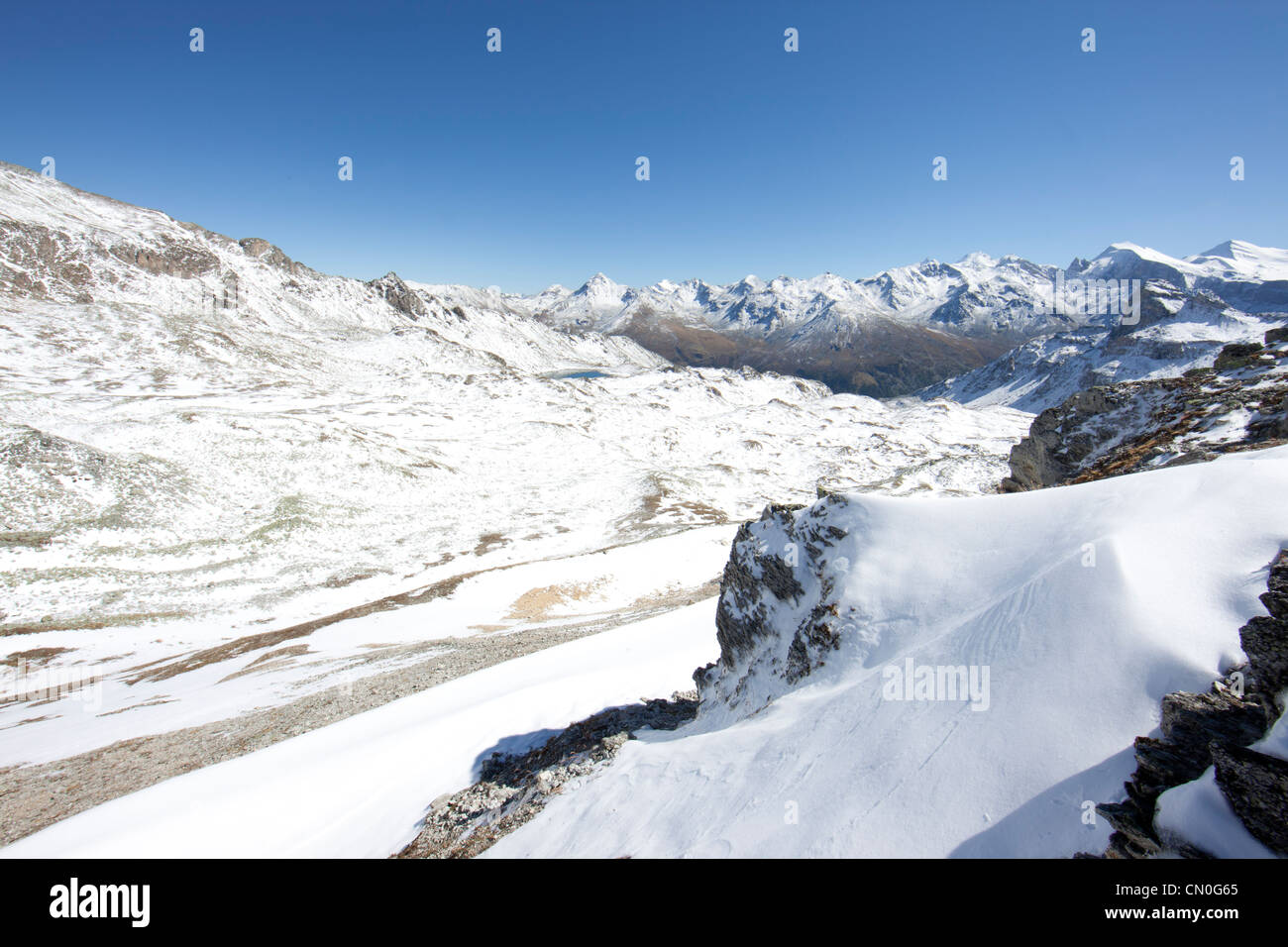 Switzerland, Haute route, view from the summit of the Meidpass (2709m) looking East with snow capped Alps. Stock Photo