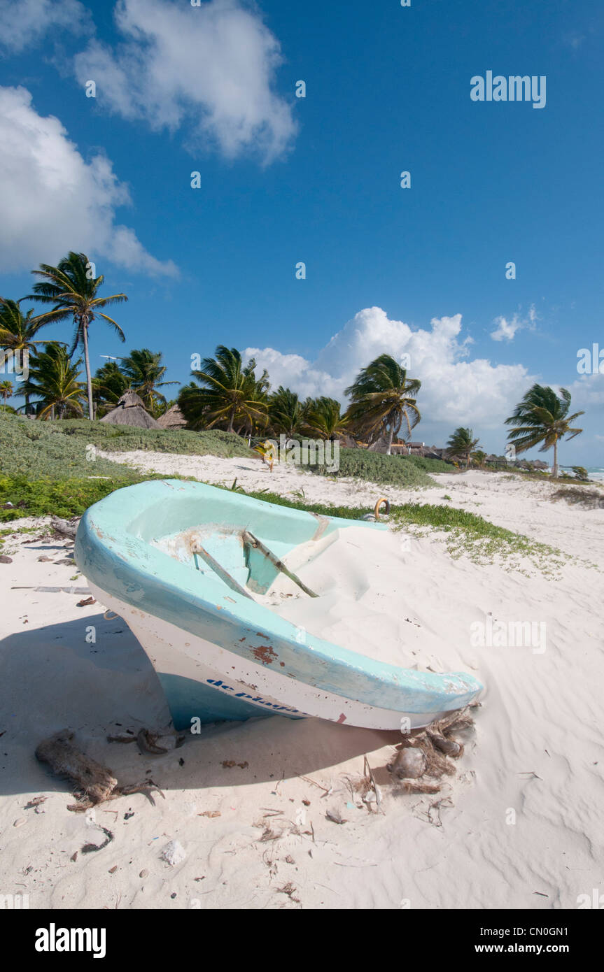 boat on beautiful empty  white sand beach Tulum Mexico Stock Photo