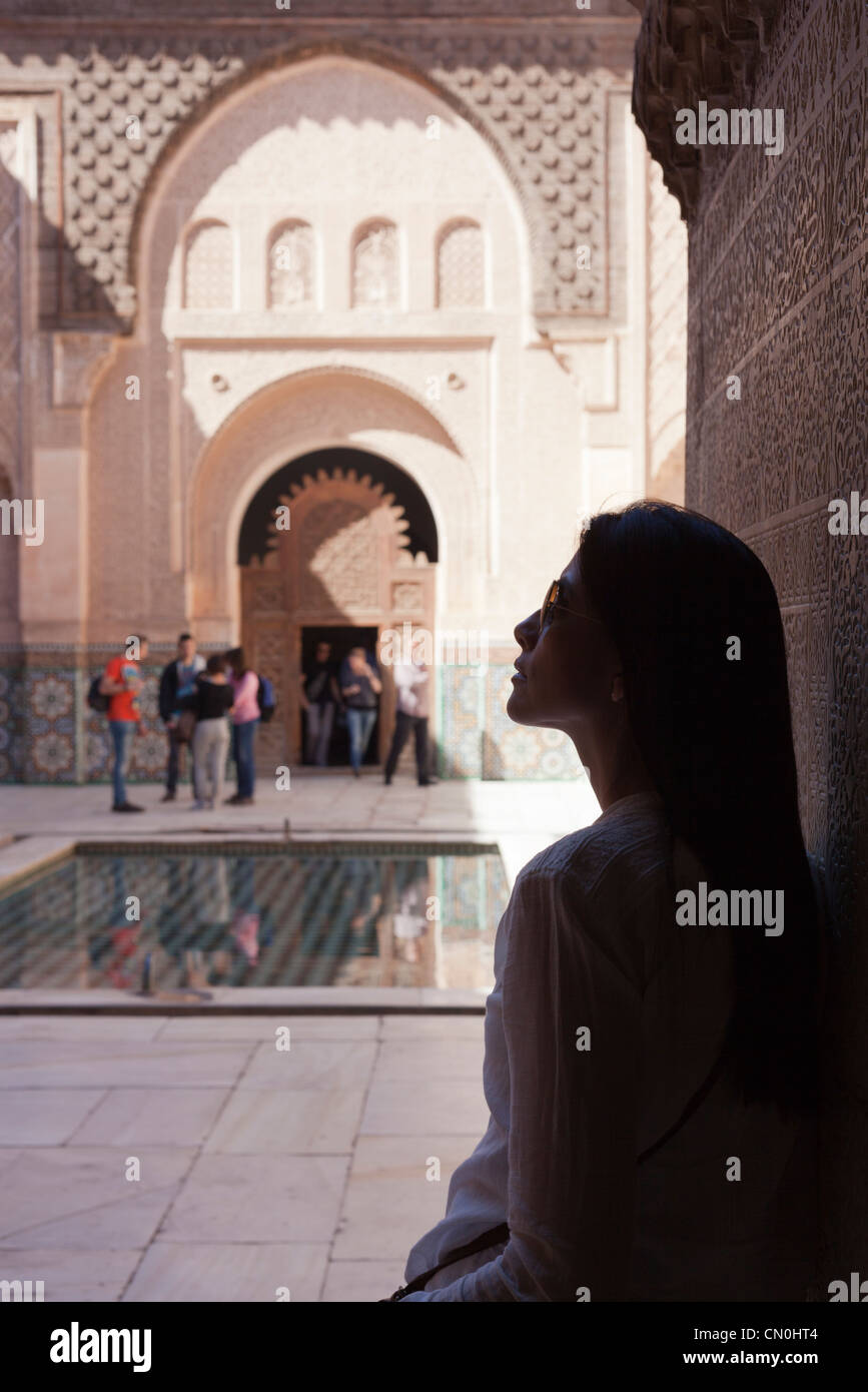 Nice woman looking from the shadows the beauty of Madrasa Ben Youssef Stock Photo
