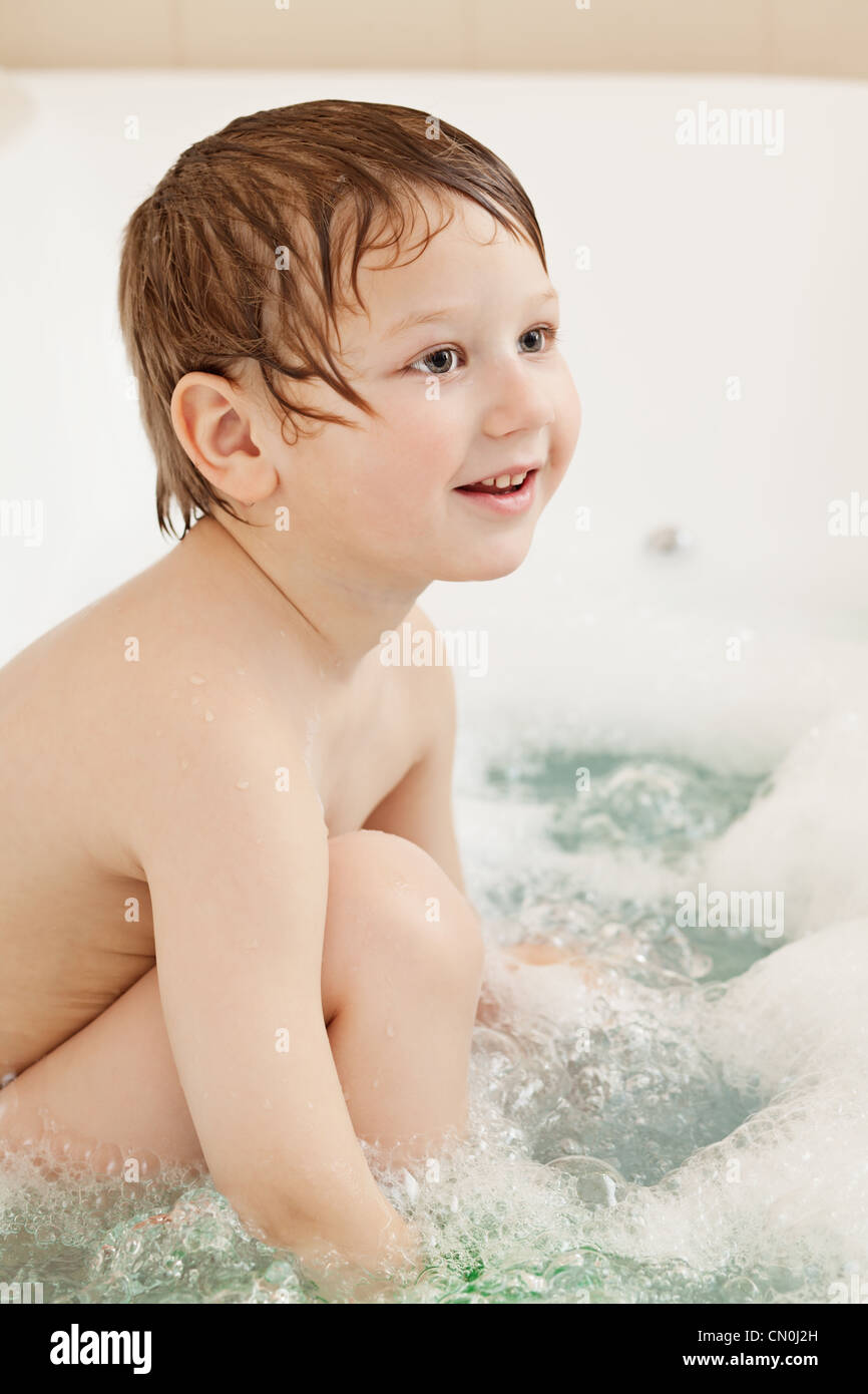 Happy little boy taking bath at home Stock Photo