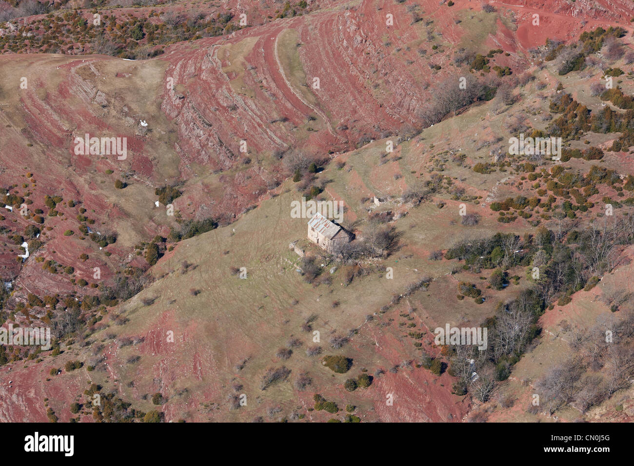 AERIAL VIEW. Lonely house in a landscape of red pelite rocks. Illion, French Riviera's backcountry, France. Stock Photo