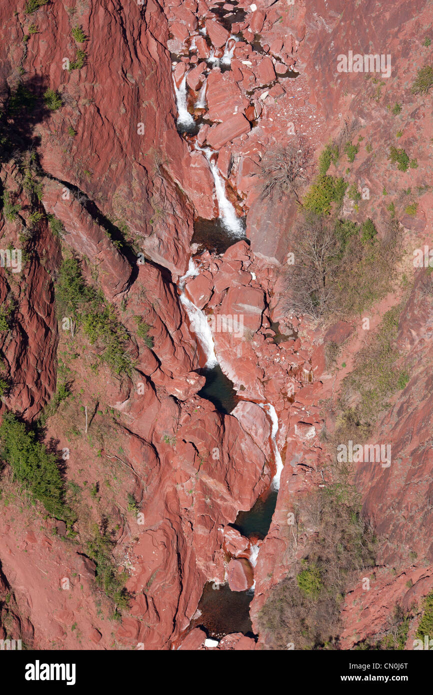 AERIAL VIEW. Waterfalls in a red pelite canyon. Cians River. French Riviera's backcountry, France. Stock Photo