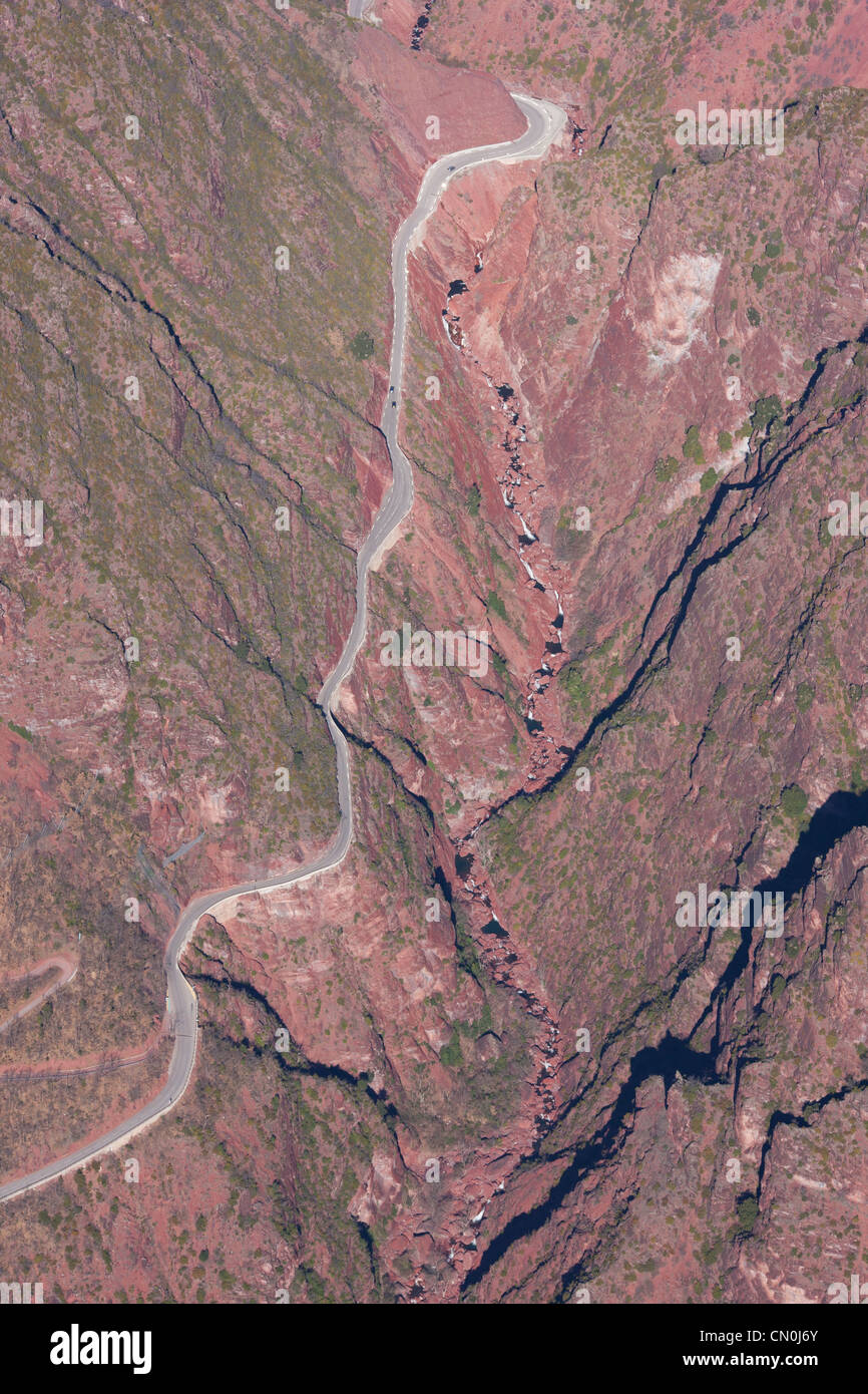 AERIAL VIEW. Road leading to the village of Beuil les Launes, crossing a deep canyon of red pelite. Cians Gorge, French Riviera's backcountry, France. Stock Photo