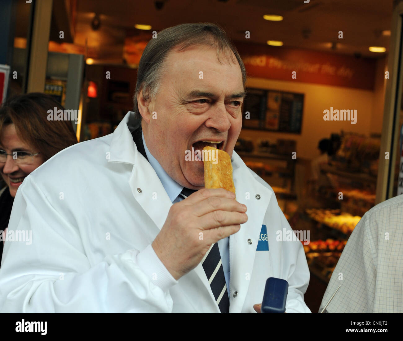 Former Deputy Prime Minister John Prescott tries out sausage roll during a visit to Greggs the Bakers in Brighton Sussex UK Stock Photo
