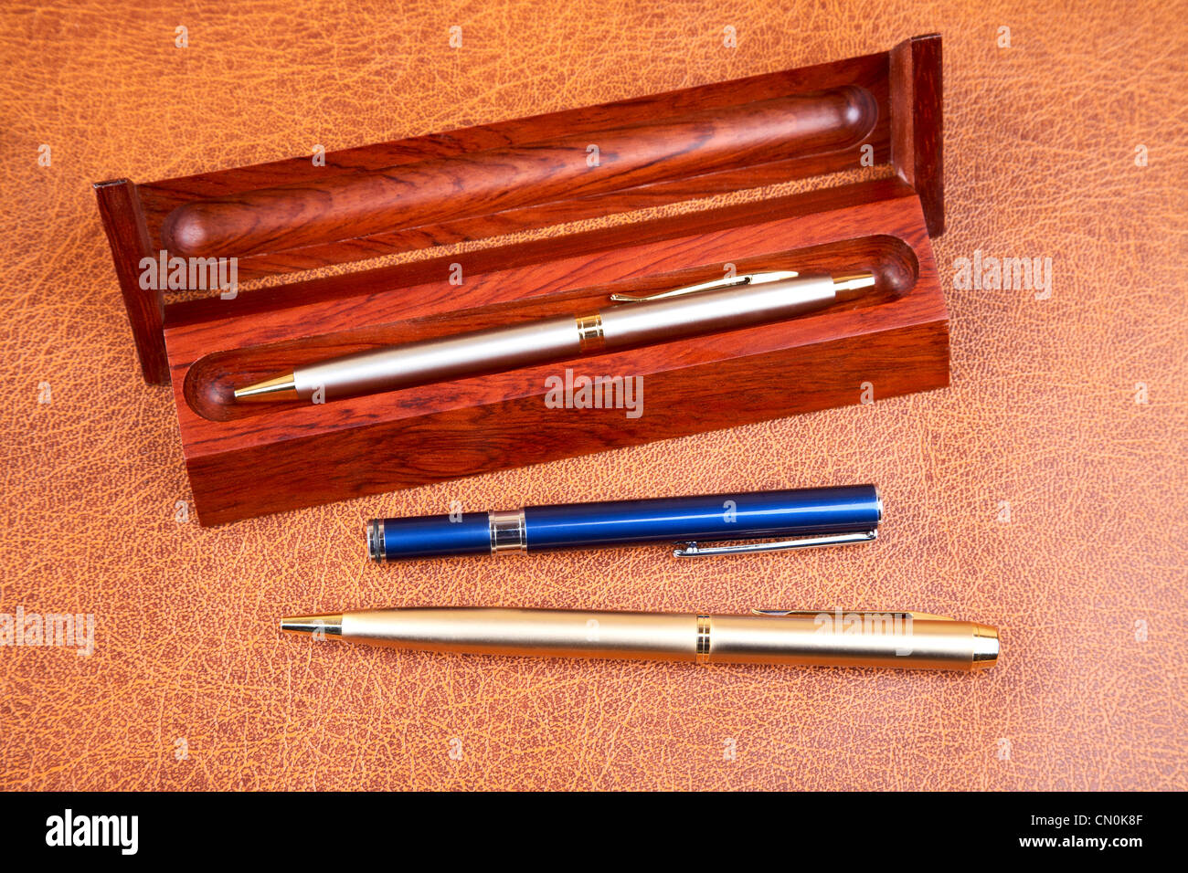 Three pens on a textural background Stock Photo