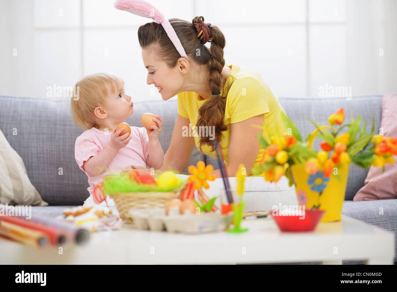 Mother and baby playing with Easter eggs Stock Photo