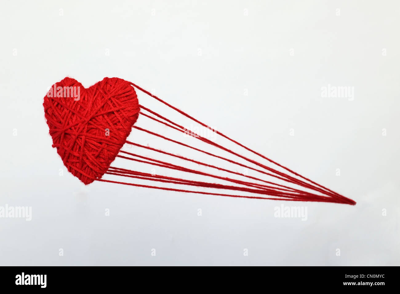 Red heart hanging on string with small clothes pins on blue background  Stock Photo by IrynaTolm