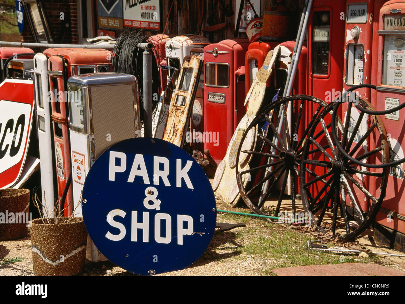 Junkyard of old signs ans gas pumps Stock Photo