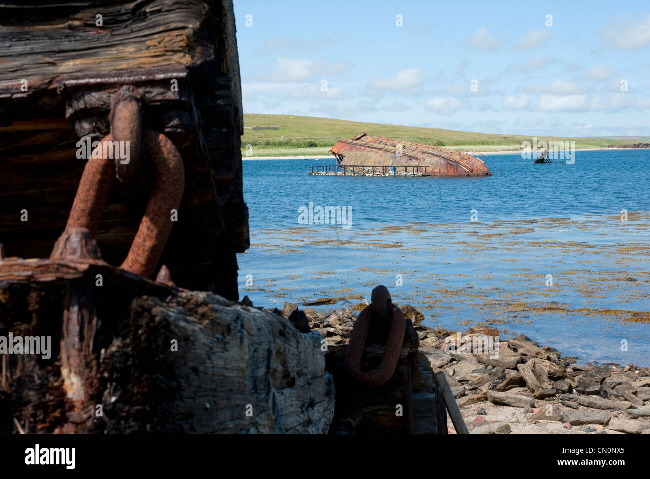 A ship wreck lies on the water of Scapa flow in the Orkney Islands Stock Photo