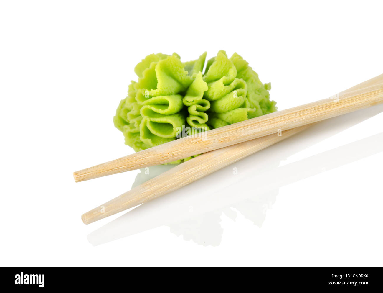 Wooden chopsticks and wasabi isolated on a white background Stock Photo