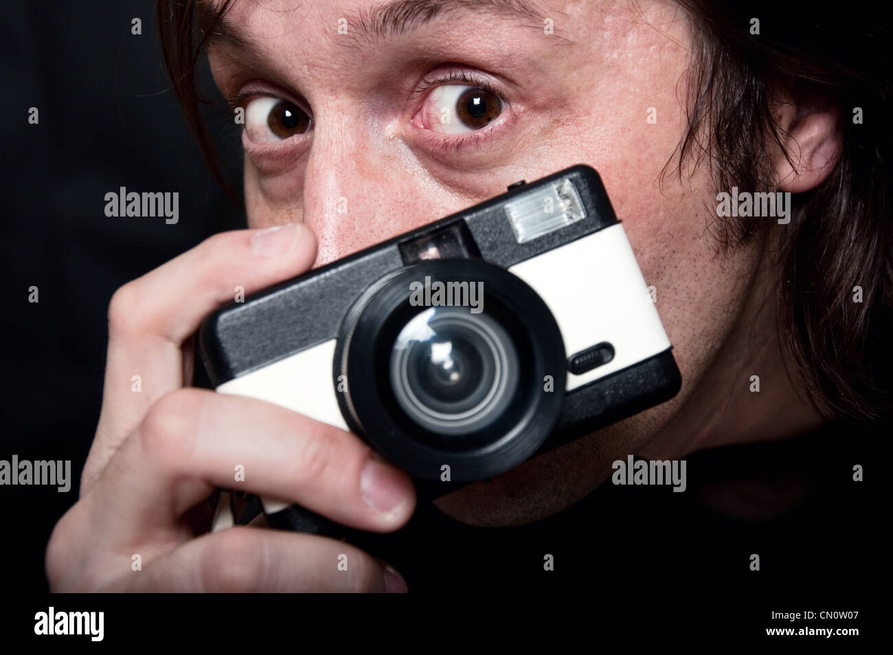 MAn with a small plastic film camera Stock Photo