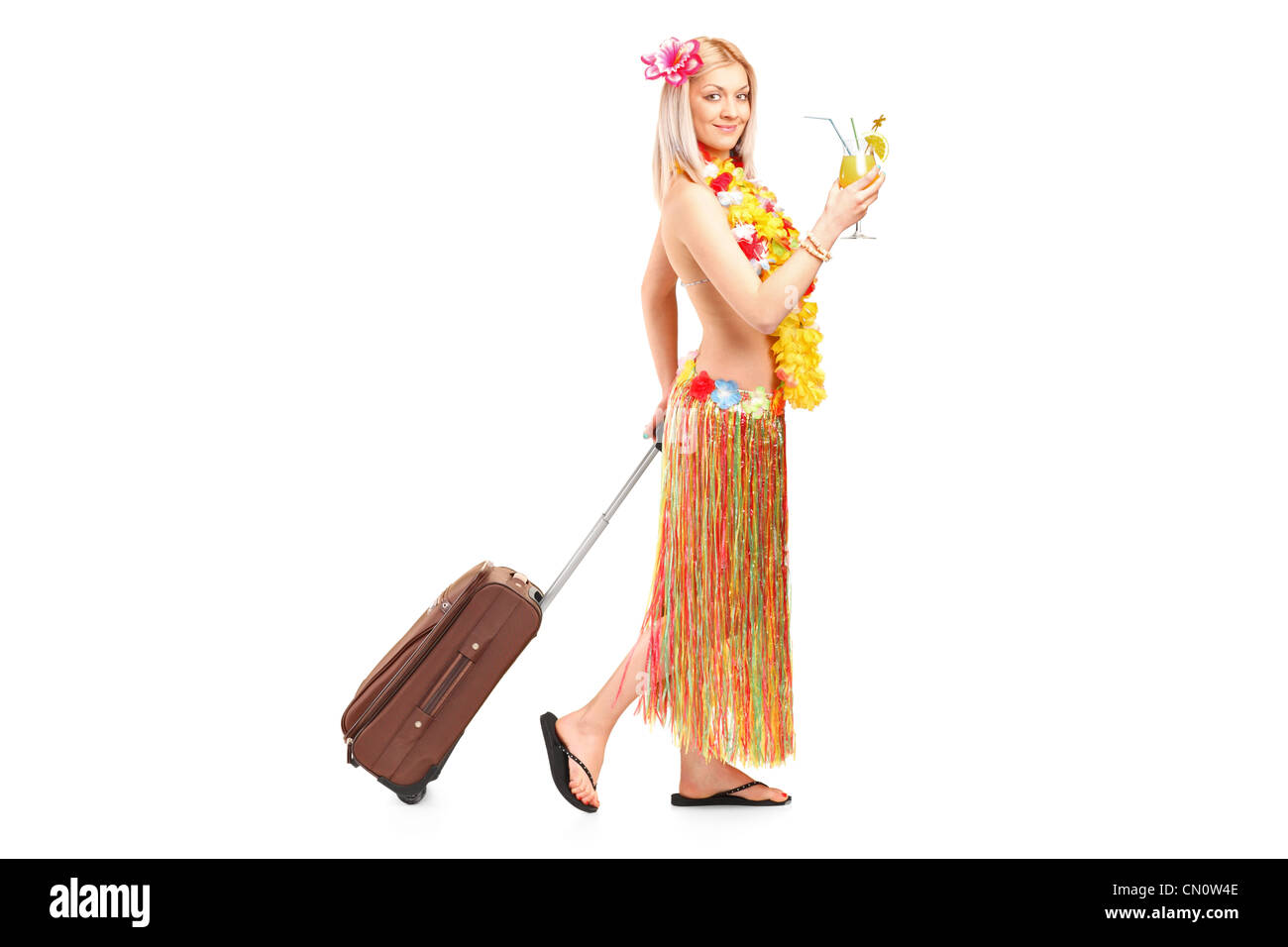 Full length portrait of an attractive woman dressed in a hawaiian costume going on vacation isolated against white background Stock Photo