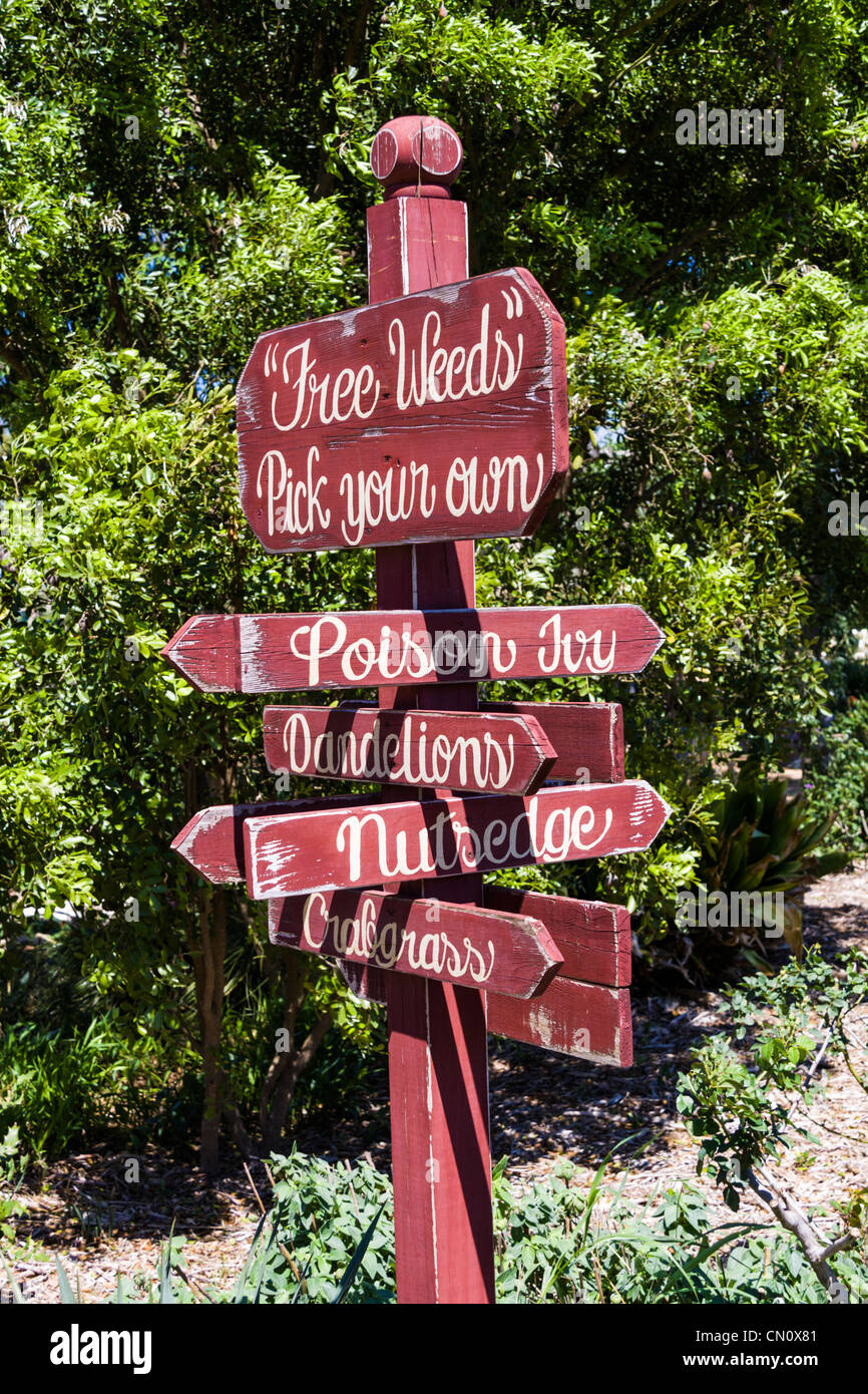 Humorous sign on Garden pathway at Rose Emporium Gardens in Brenham, Texas. Stock Photo