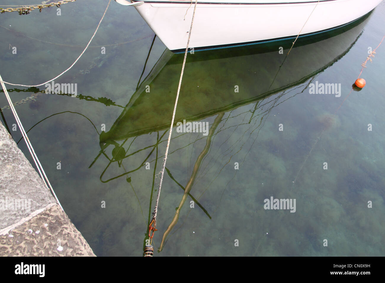 Sailboats moored and reflected on the water Stock Photo - Alamy