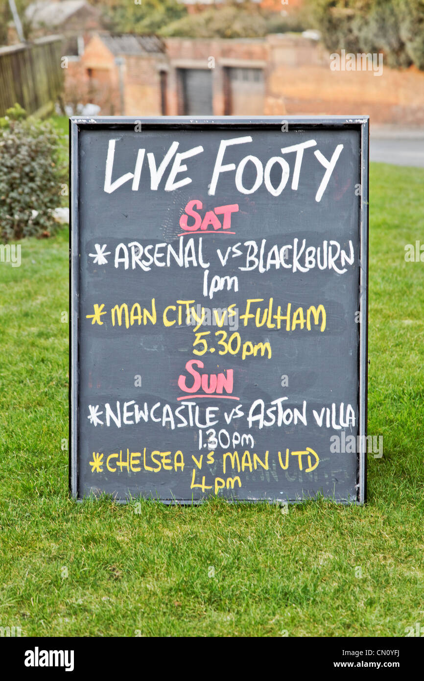 Bar sign outside a UK public house showing live soccer matches itinery to drum up business from footy fans Stock Photo