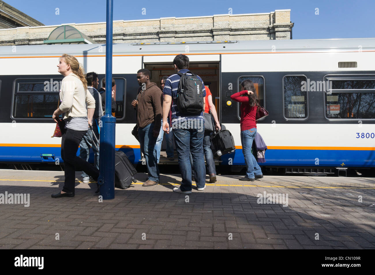 People and passengers getting on and off a train at West Brompton