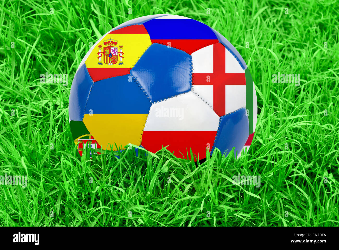 Soccer ball on grass field background. Ball filled with euro 2012