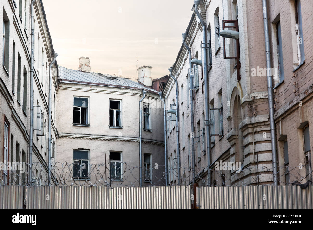 Open windows in run-down apartment building Stock Photo