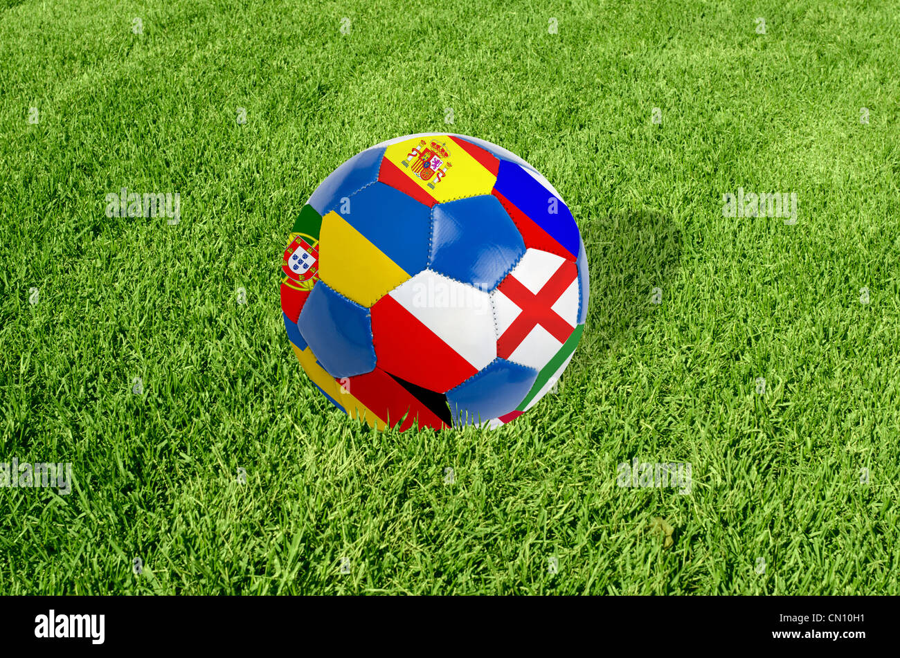 Soccer ball on grass field background. Ball filled with euro 2012